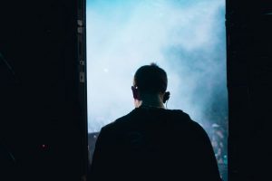 Temný klubový koncert s červeným světlem a kouřem