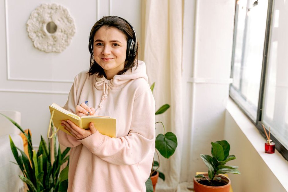 Zápisník a sluchátka na pracovním stole autora